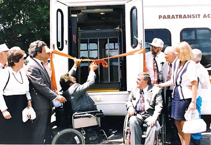 People celebrating launch of Paratransit services