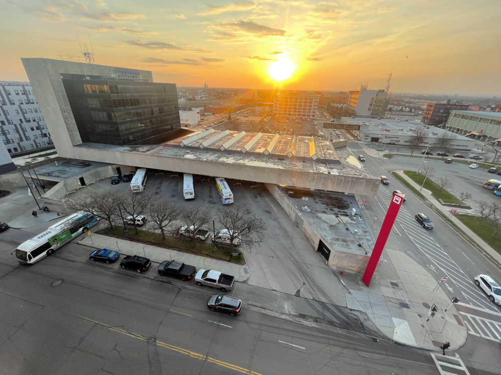 An Outdoor Photo of the Metro Transporation Center Bus station with the Sun rising.