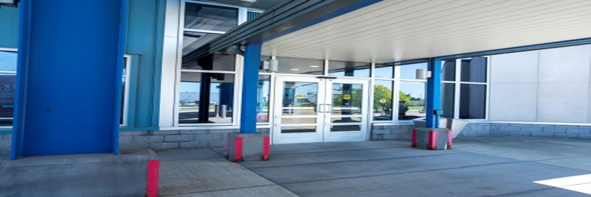 Exterior view of Niagara Falls Transportation center showing a bus to the left and landscaping.
