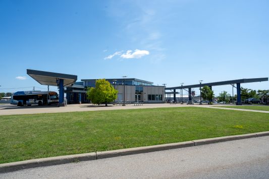 Exterior view of Niagara Falls Transportation center showing a bus to the left and landscaping.