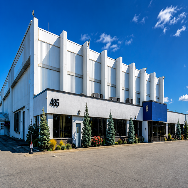 Exterior photo of 485 Cayuga showing a white building with a blue sky.