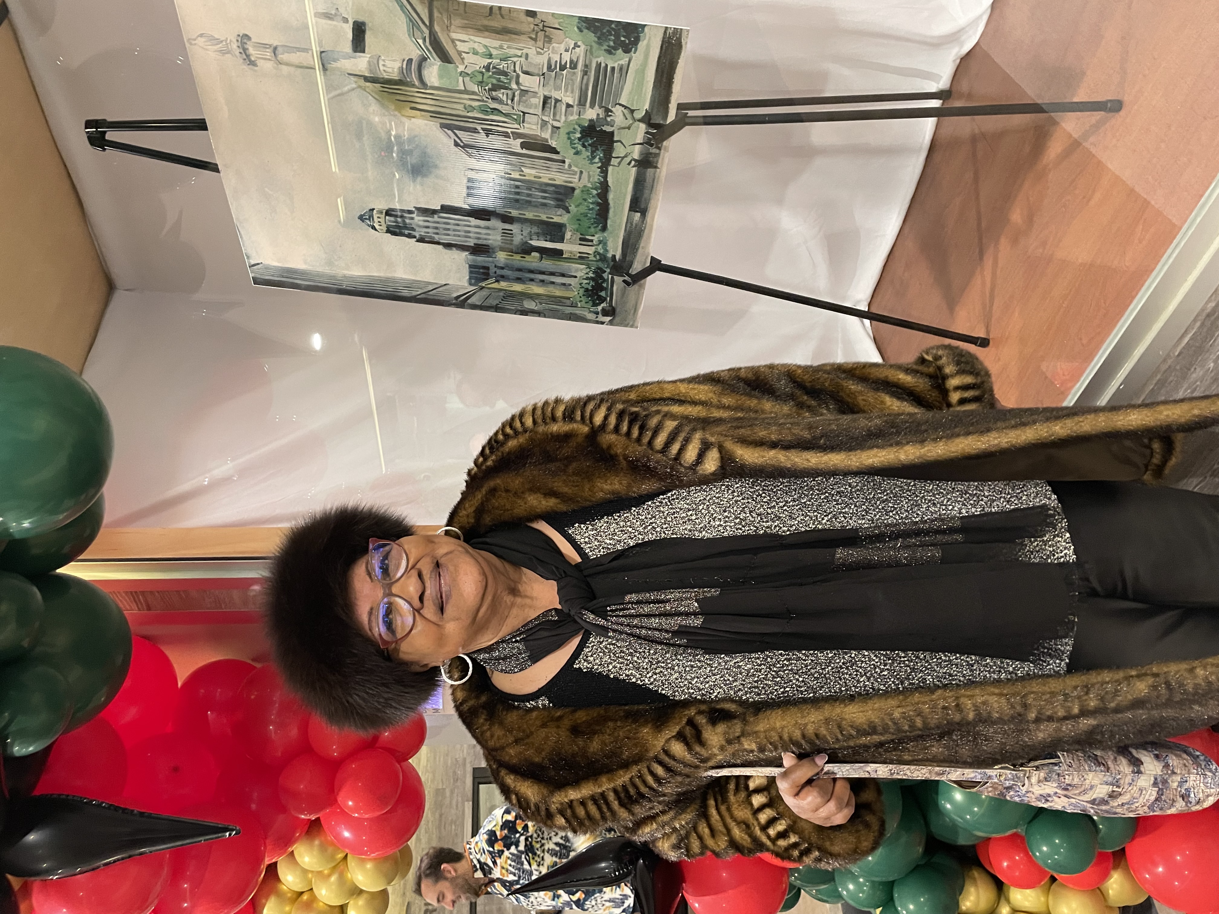 Sharon West in front of her father's painting 